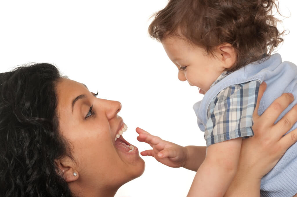 Toddler Smiling With His Mom